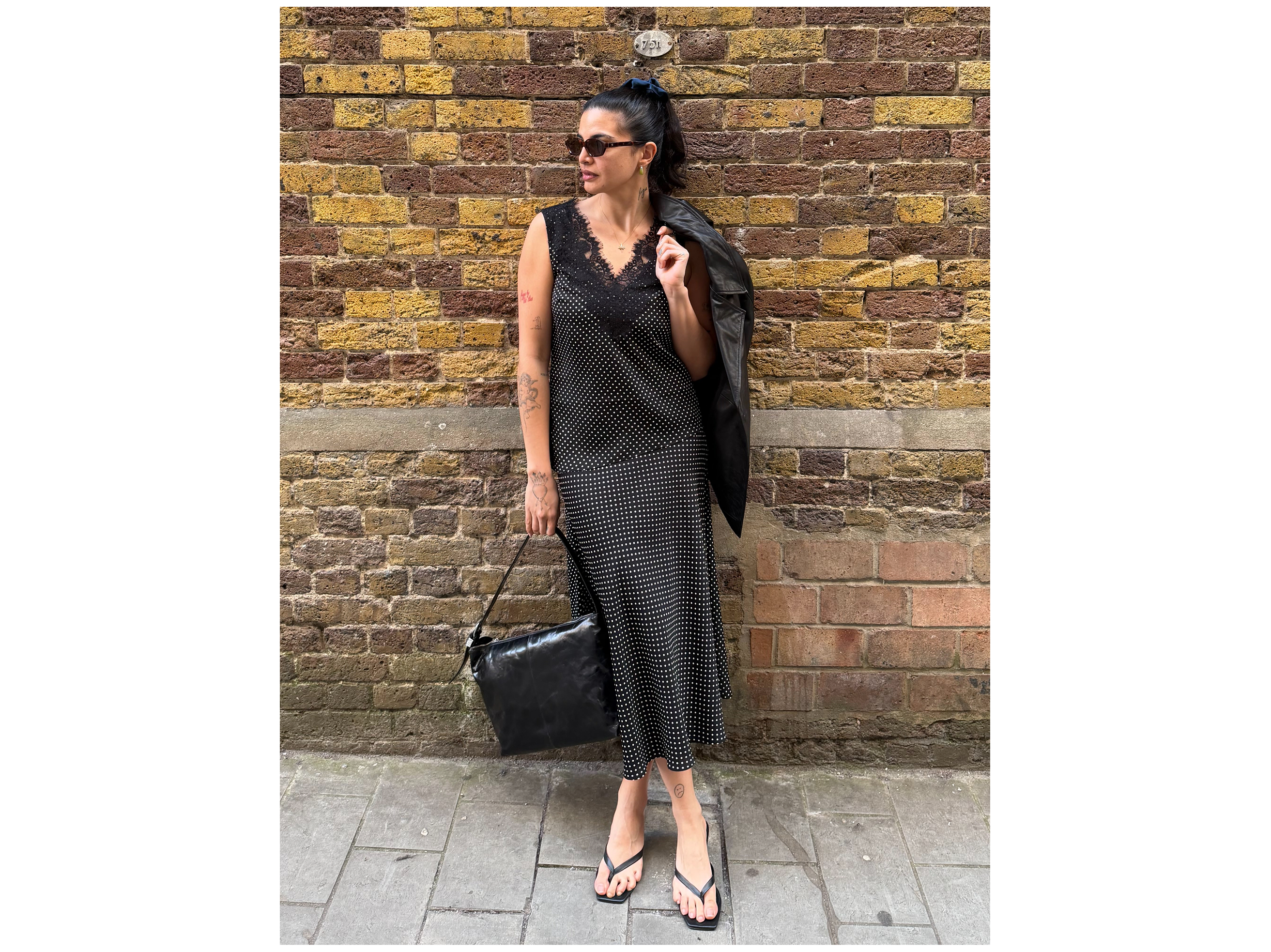 Emma Breschi posing for a picture against a wall