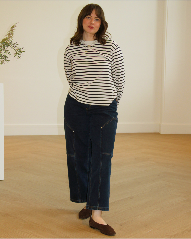 Woman standing for picture in striped jersey